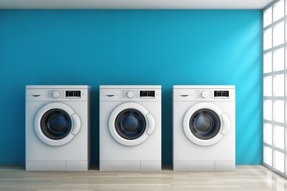 Three tumble dryers are used in a tutorial on how to dry clean clothes at home, featuring Sta-Soft's fabric care tips.